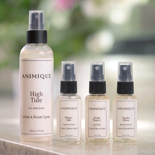 Three Animique pet-safe linen sprays on a marble countertop.