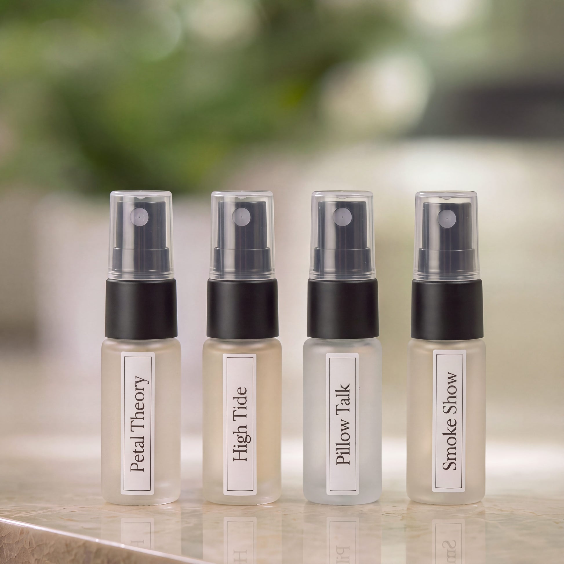 Four discovery bottles of Animique pet-safe linen and room spray on a marble countertop